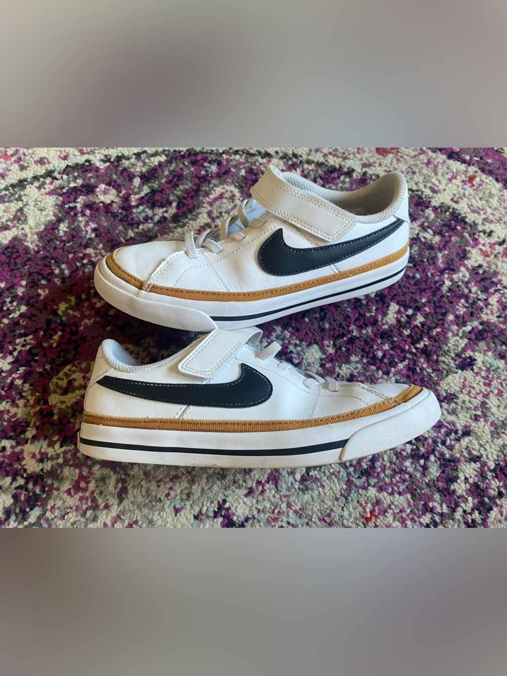 Nike White Kids Sneakers with Black Swoosh and Gold Accent